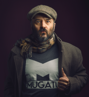 Stylized portrait of a bearded man wearing a flat cap and scarf, giving a thumbs-up gesture, used as an example photo for AI-powered image-to-3D character modeling